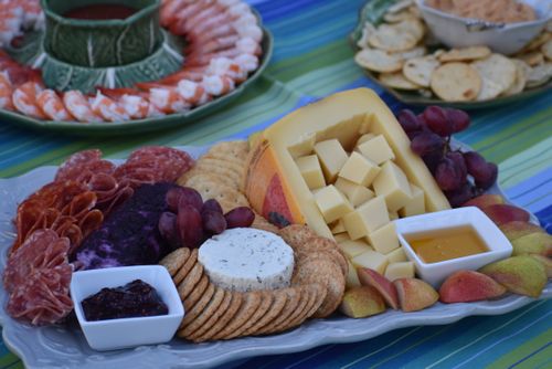 Free Elegant charcuterie board with assorted cheeses, meats, and fruits for a perfect gathering. Stock Photo