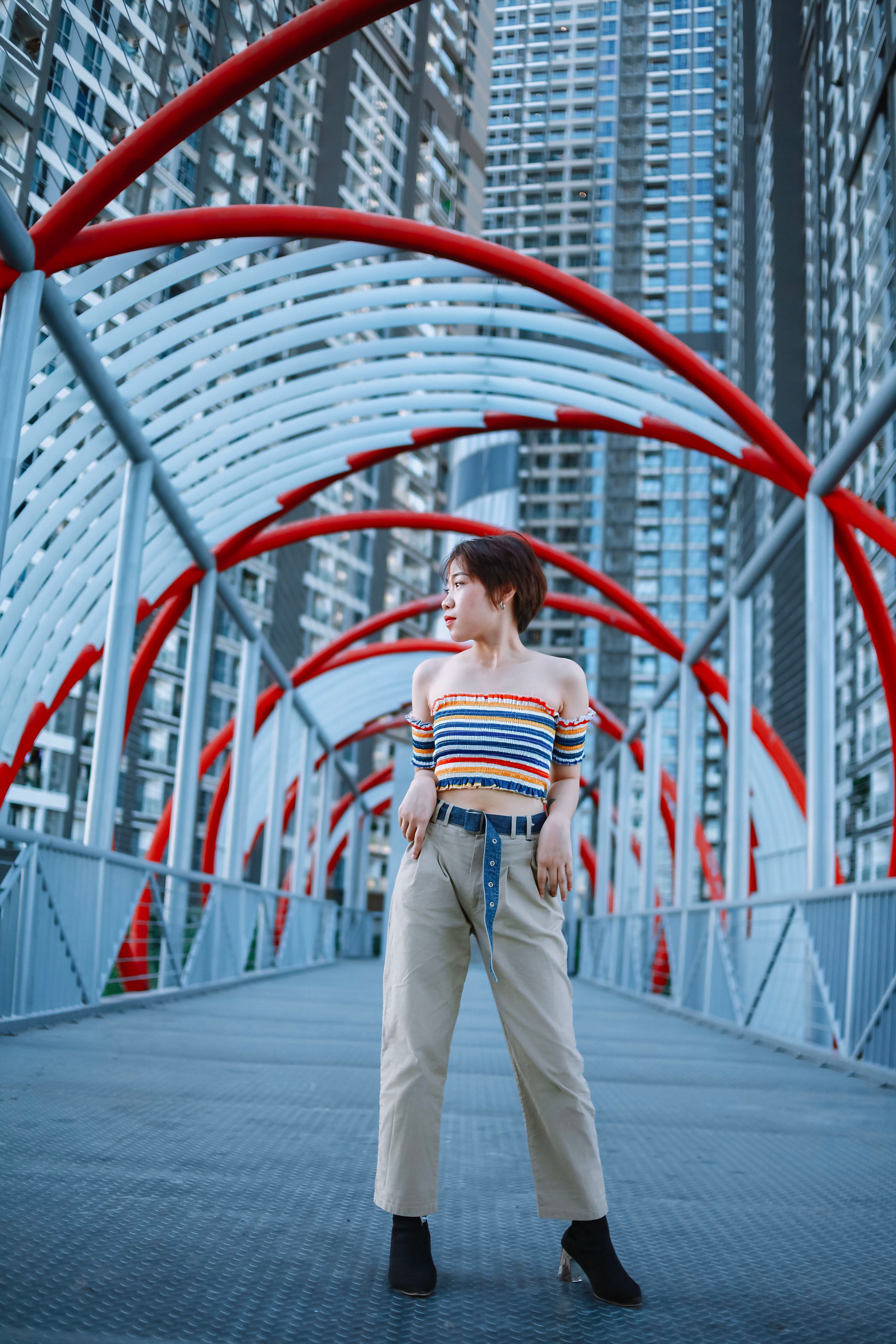 Woman Posing on Modern Metallic Urban Bridge · Free Stock Photo