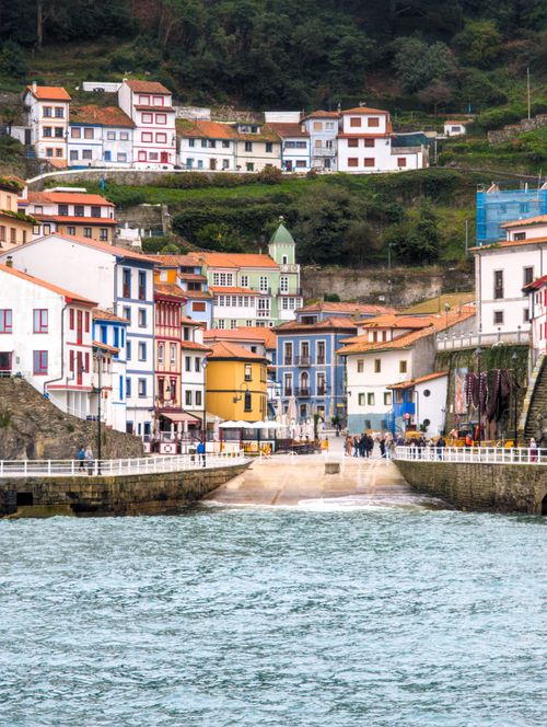 Free Colorful houses lining the harbor in the picturesque coastal village of Cudillero, Spain. Stock Photo