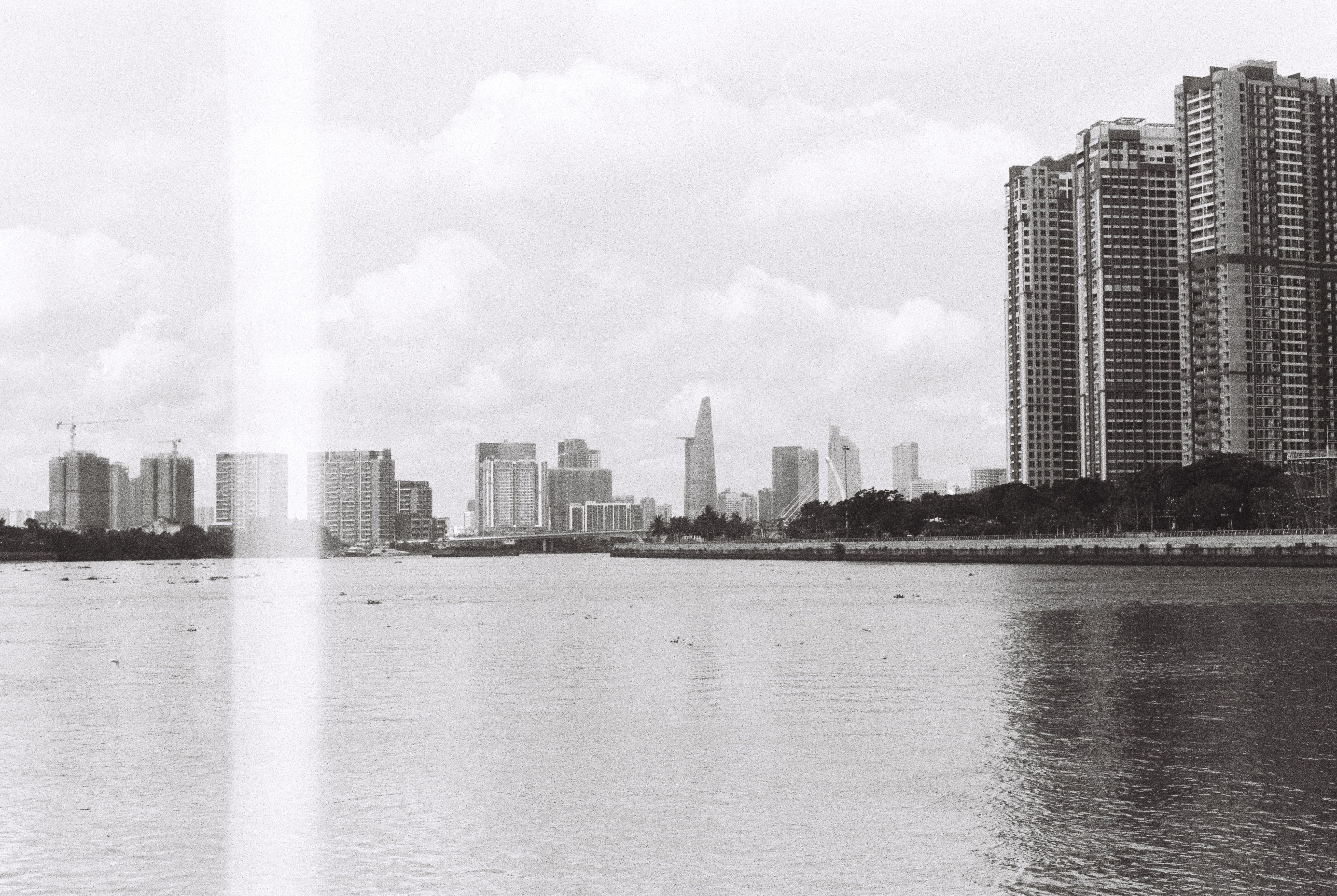 Black and White Urban Skyline Reflected in River · Free Stock Photo