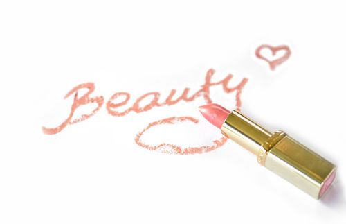 Free Close-up of pink lipstick next to 'Beauty' written on paper with a heart. Stock Photo