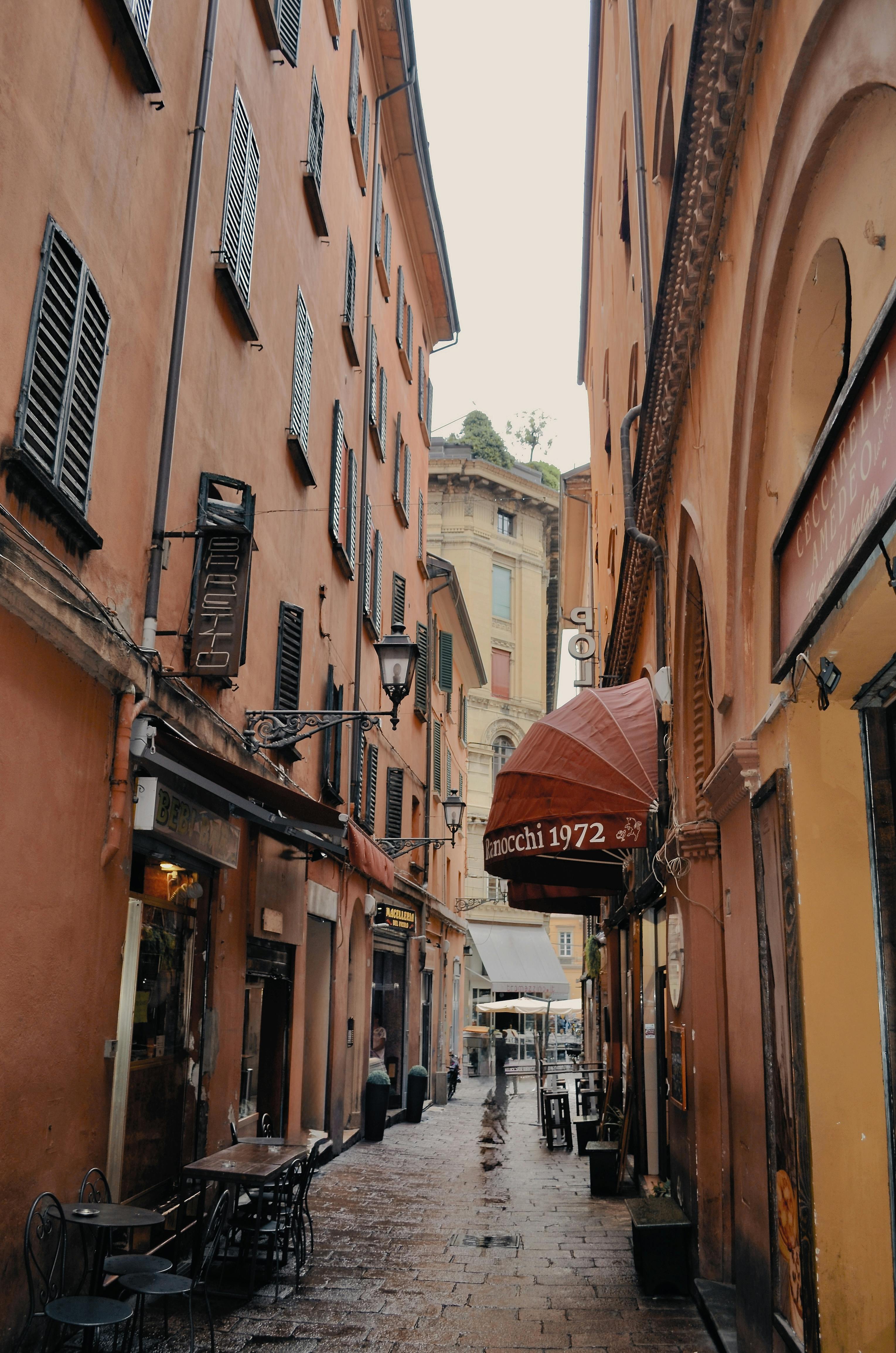 Explore a picturesque arcade alley in Bologna, Italy, showcasing classic architecture.