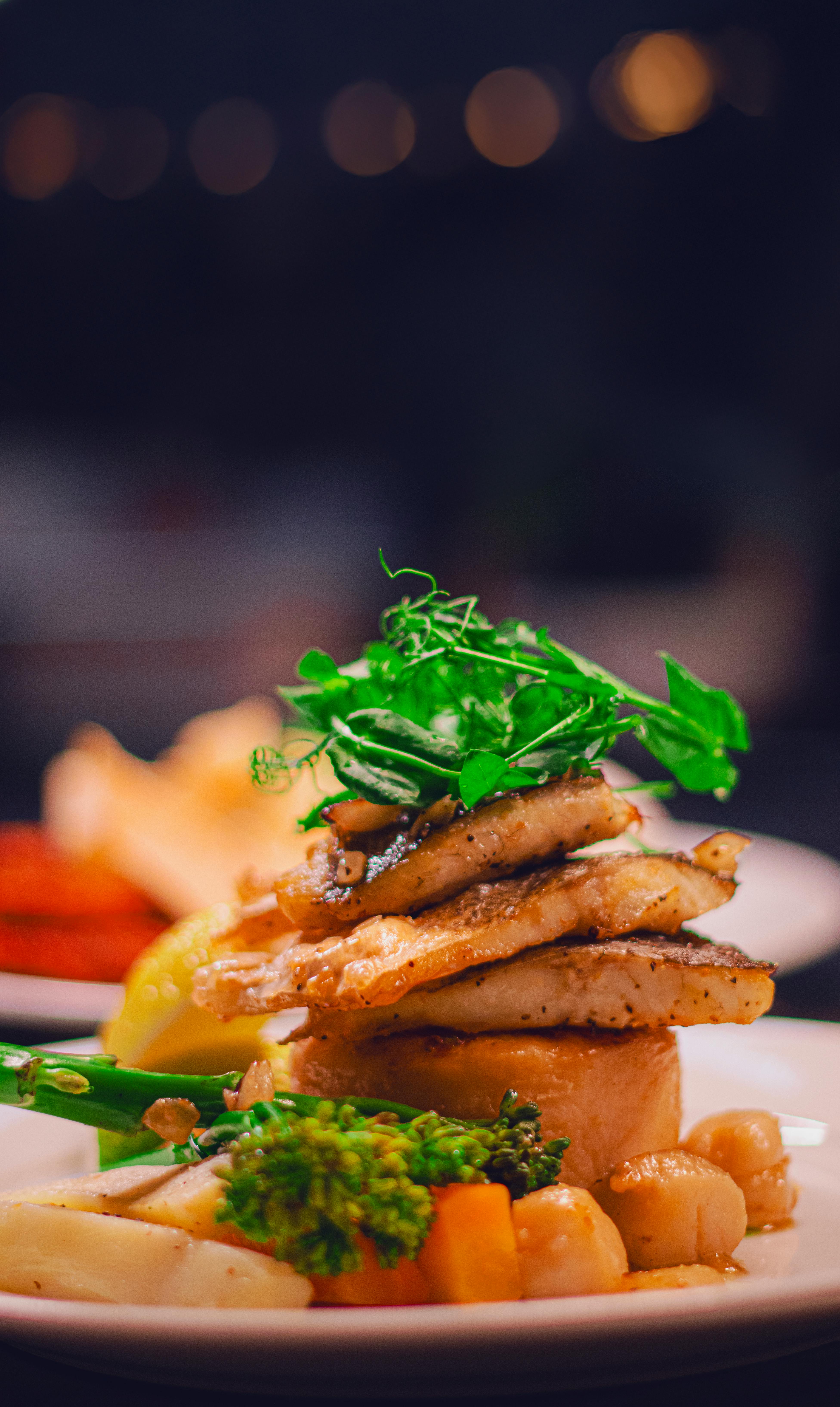 Delicious gourmet fish dish elegantly plated with fresh vegetables, perfect for culinary enthusiasts.