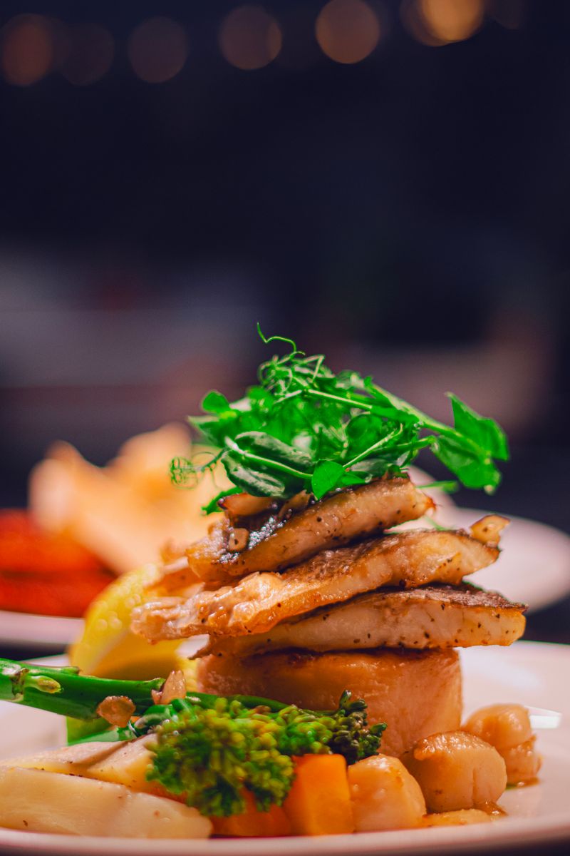 Delicious gourmet fish dish elegantly plated with fresh vegetables, perfect for culinary enthusiasts.