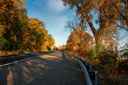 A beautiful autumn road with vibrant fall foliage in Maple Springs, Minnesota.