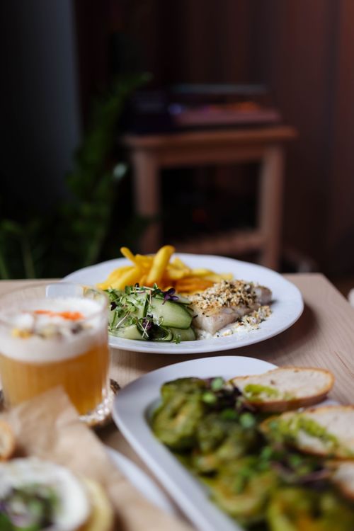 Free Delicious vegetarian meal with fresh veggies, grains, and a smoothie on a cozy table setting. Stock Photo