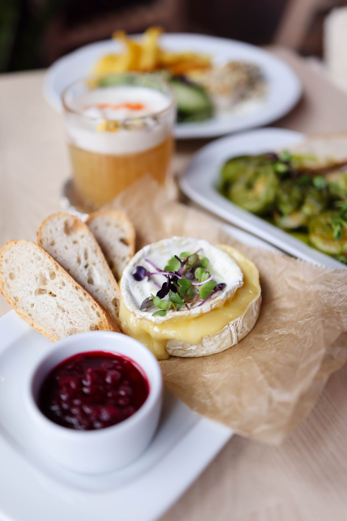 Whipped cheese on toast with berry compote and fresh greens