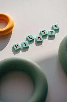 Top view of colorful foam rings and PILATES text, perfect for fitness themes.