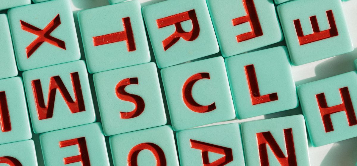 Colorful letter tiles arranged in light