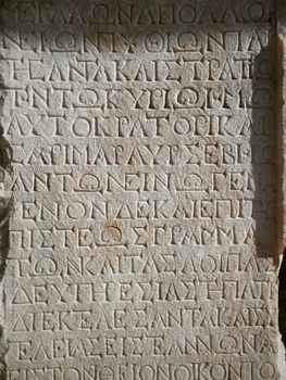 Close-up of an ancient Greek inscription on stone in Pamukkale, Türkiye.