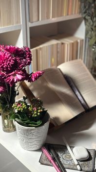 An inviting reading nook with a book, decorative flowers, and a cozy atmosphere.