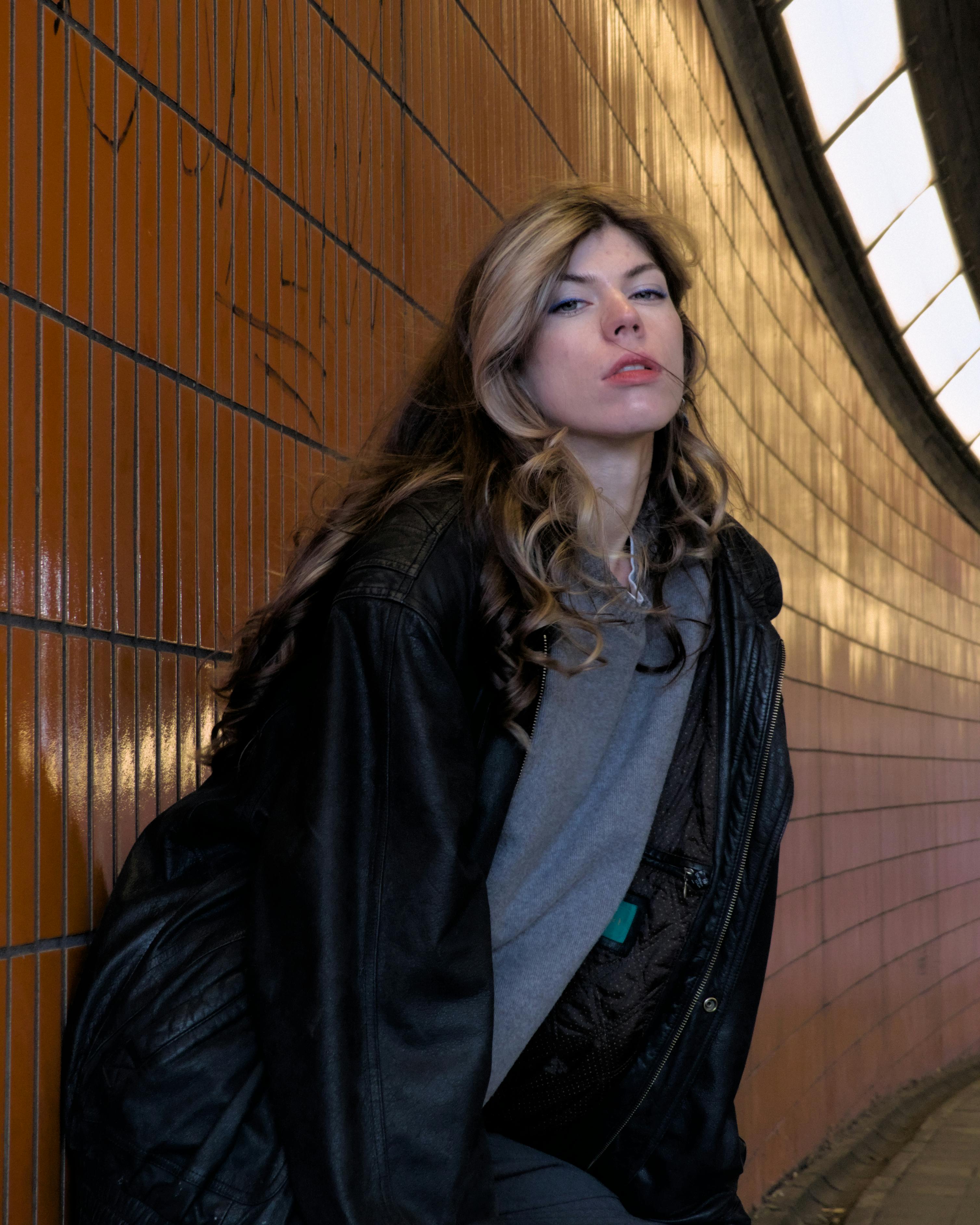 young woman in urban tunnel with orange tiles