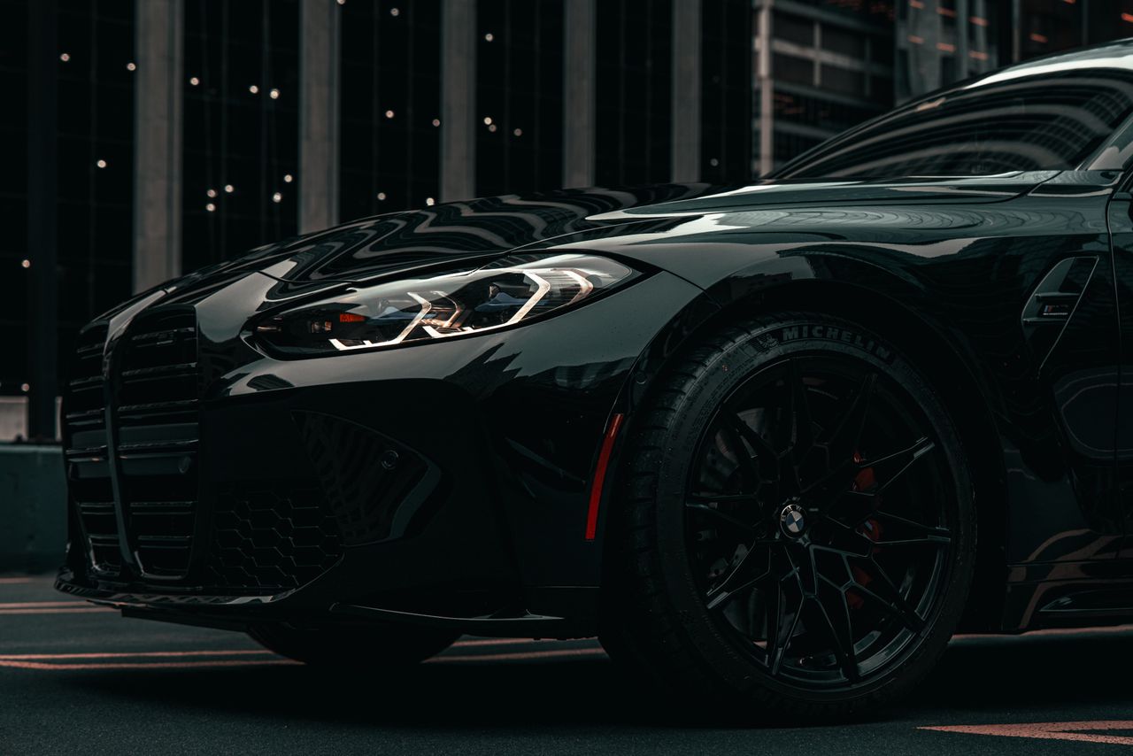 a dramatic shot of a modern black bmw car in downtown chicago showcasi