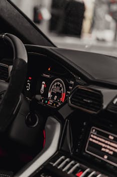 Sleek interior of a luxury car featuring a modern dashboard and premium steering wheel.