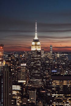 A breathtaking twilight view of the iconic New York City skyline featuring the Empire State Building.