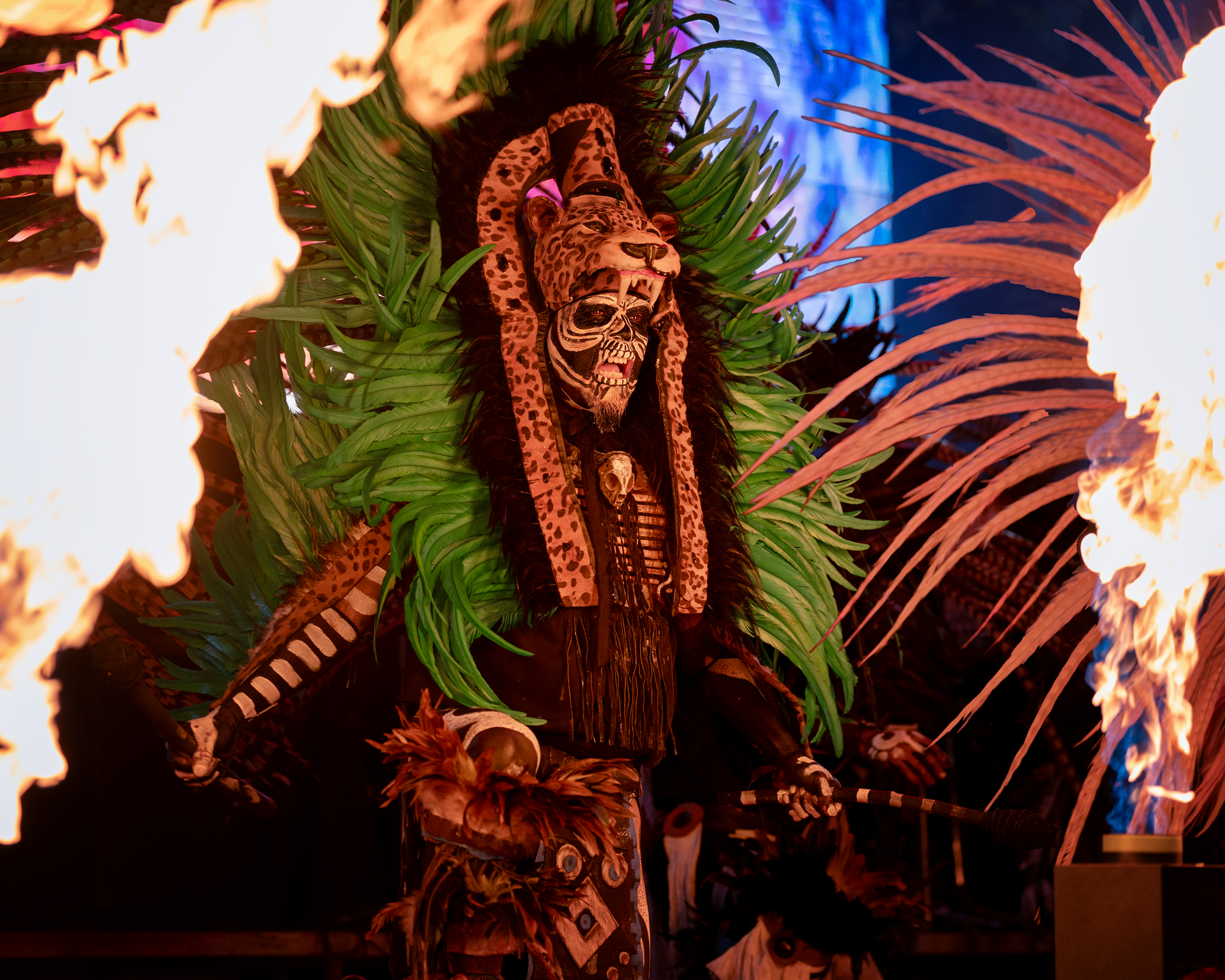 Dramatic depiction of a Mexican ritual with fire, dance, and a jaguar mask, highlighting cultural heritage.