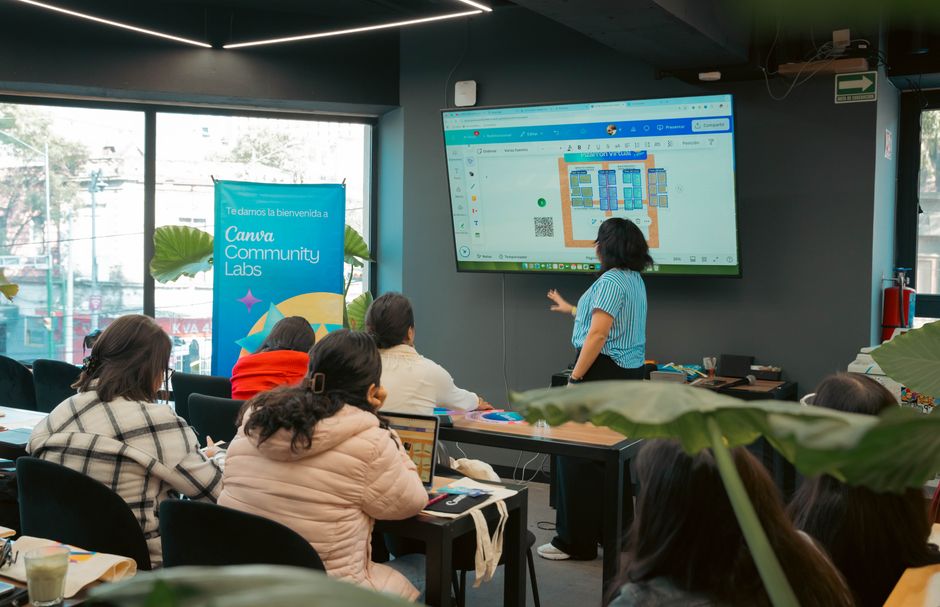 Interactive workshop session at Canva Community Labs with a presentation screen and engaged audience.