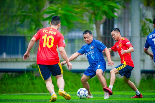 Amateur soccer players in action during a local match in Hà Nội, Vietnam.