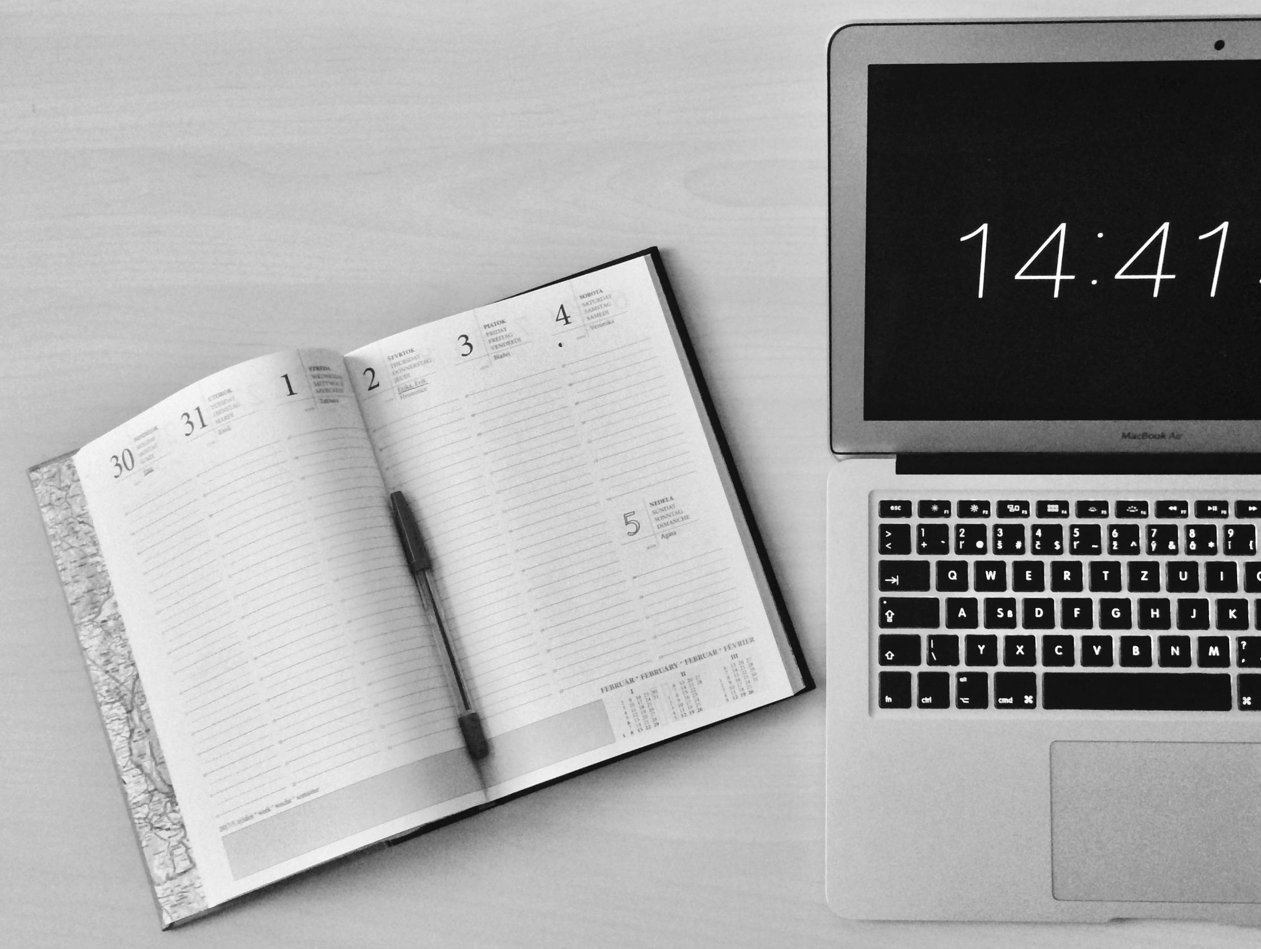 Free Flat Lay Photography of Unfold Book Beside Macbook Stock Photo