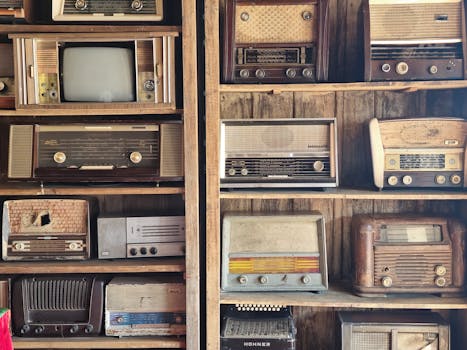 A nostalgic display of vintage radios and retro TV on wooden shelves, capturing timeless charm in Dubai.