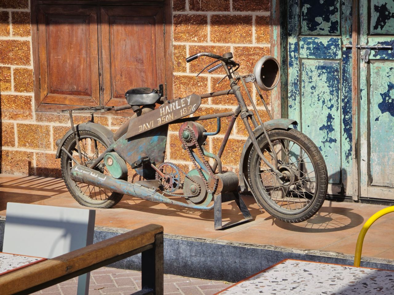 rusty antique harley davidson motorcycle displayed outdoors in dubai