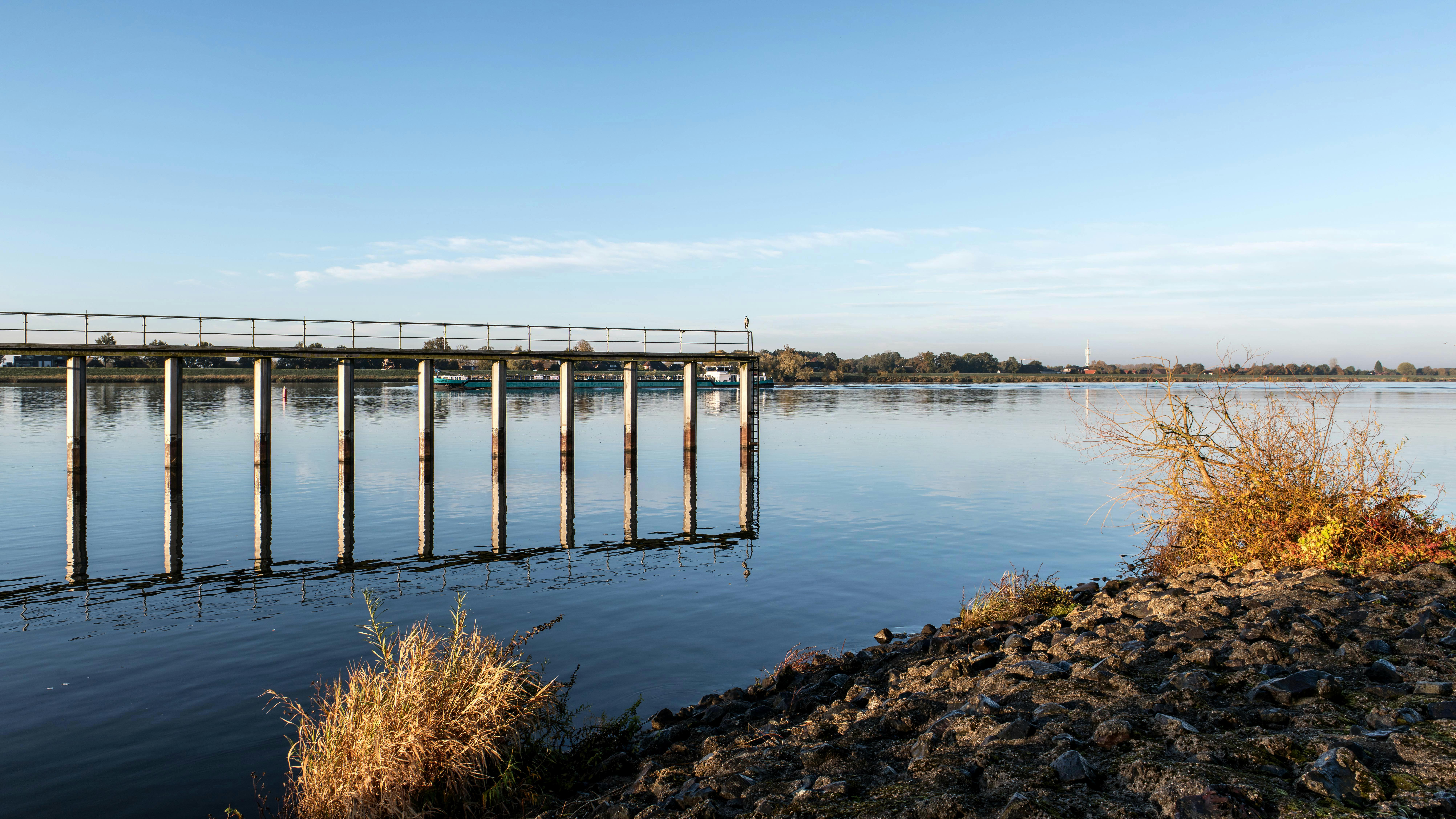 scenic river view with old bridge at sunrise