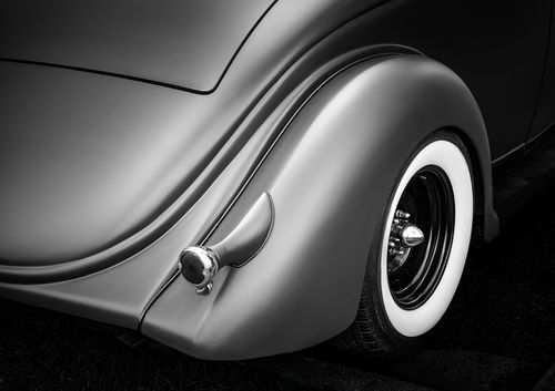 Free Monochrome photo highlighting the elegant design of a classic vintage car's wheel. Stock Photo