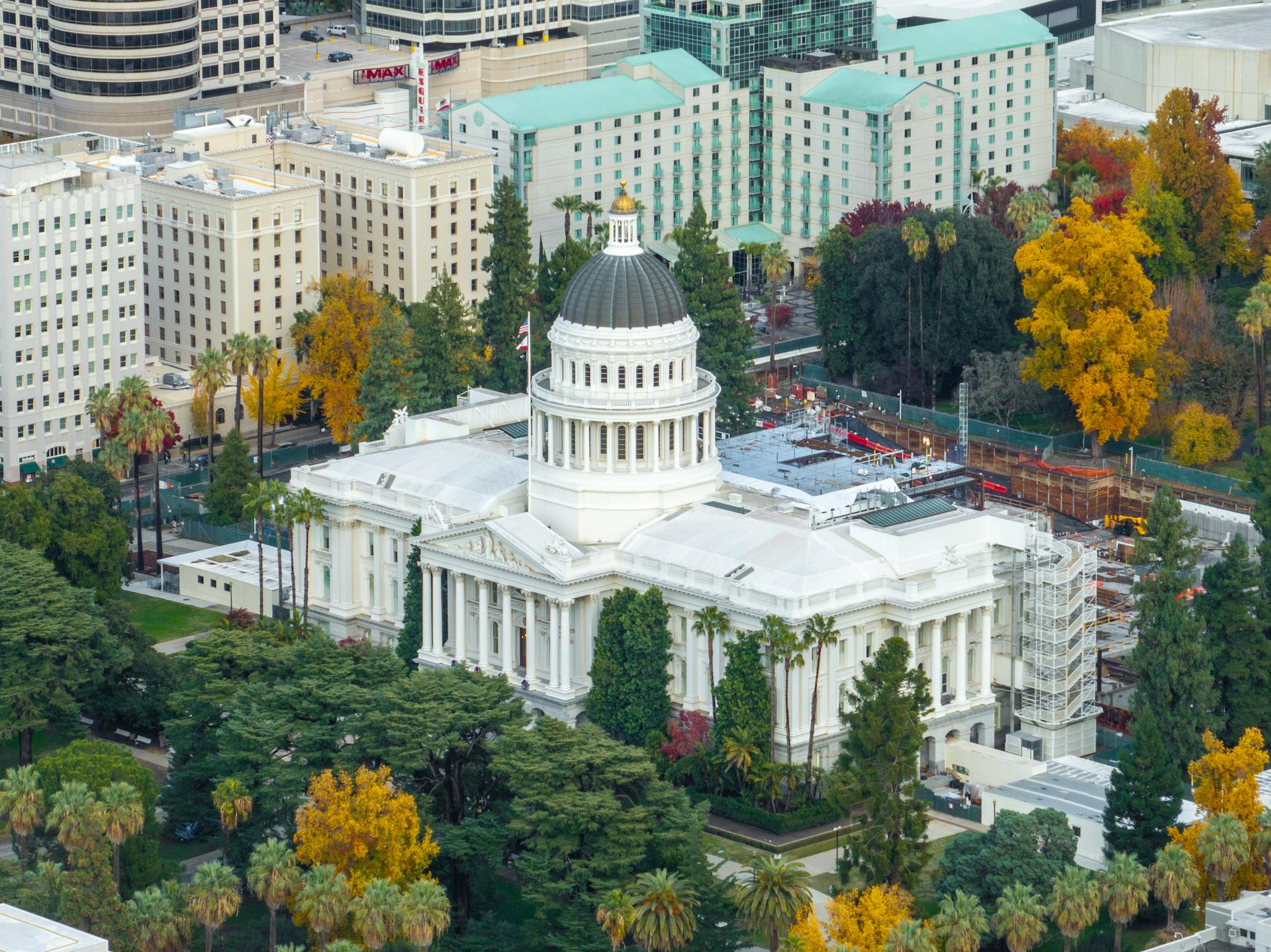 Aerial shot of the California State Capitol surrounded by colorful autumn foliage in downtown Sacramento.