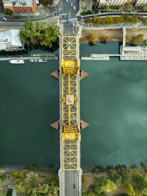 Free Stunning aerial view of Sacramento's Tower Bridge, a vibrant yellow landmark over the river. Stock Photo