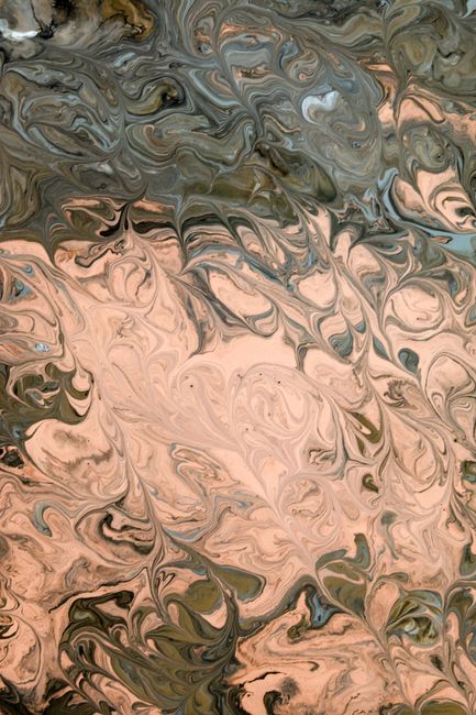 Abstract artwork featuring swirling patterns in earthy tones, creating a dynamic and artistic visual.