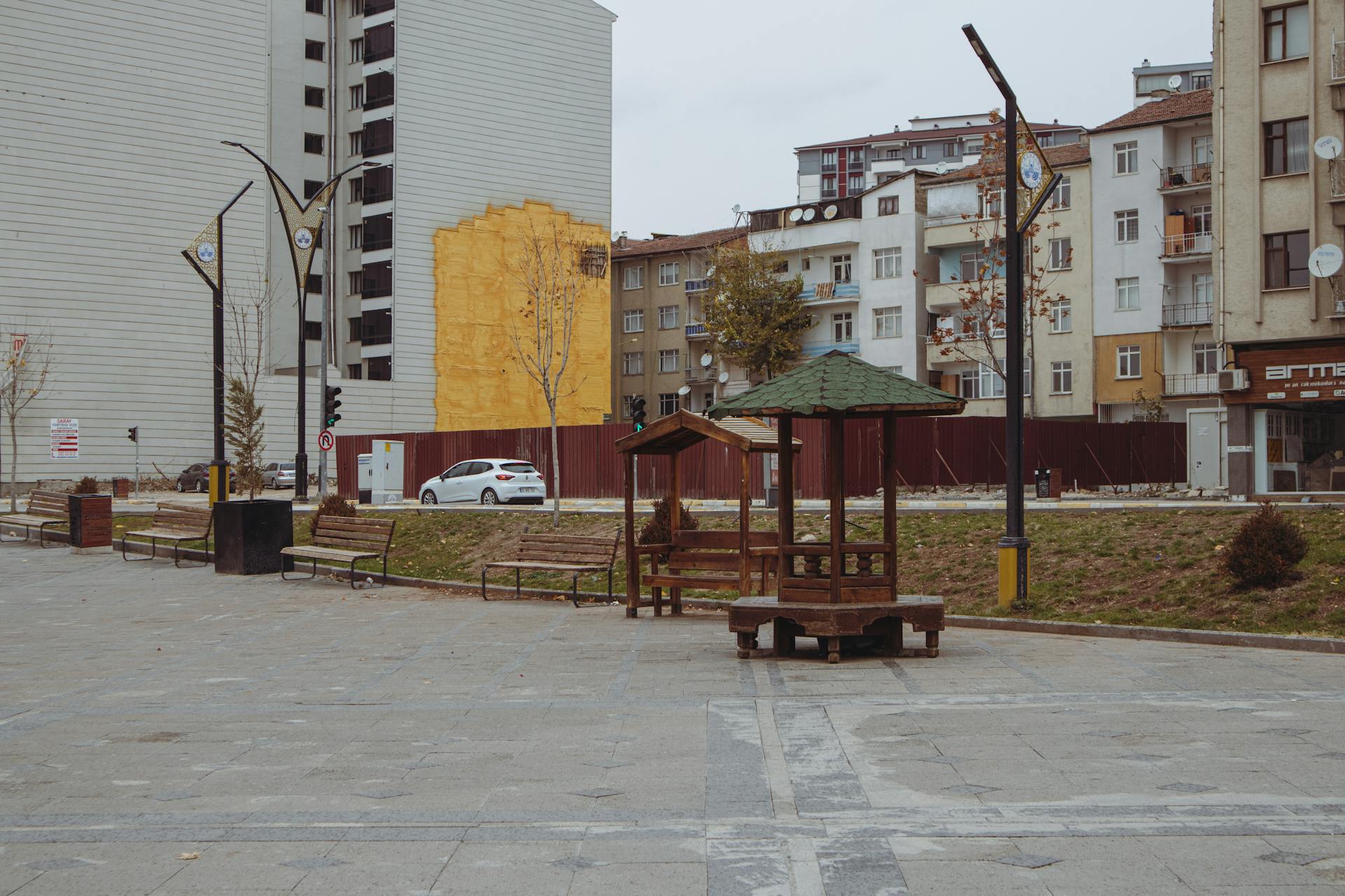 Empty urban square with benches and buildings in Elâzığ, Türkiye.