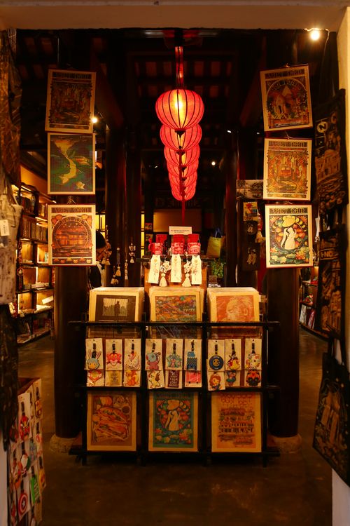 Free Explore a vibrant art shop in Hội An, showcasing traditional Vietnamese prints and crafts under a red lantern. Stock Photo