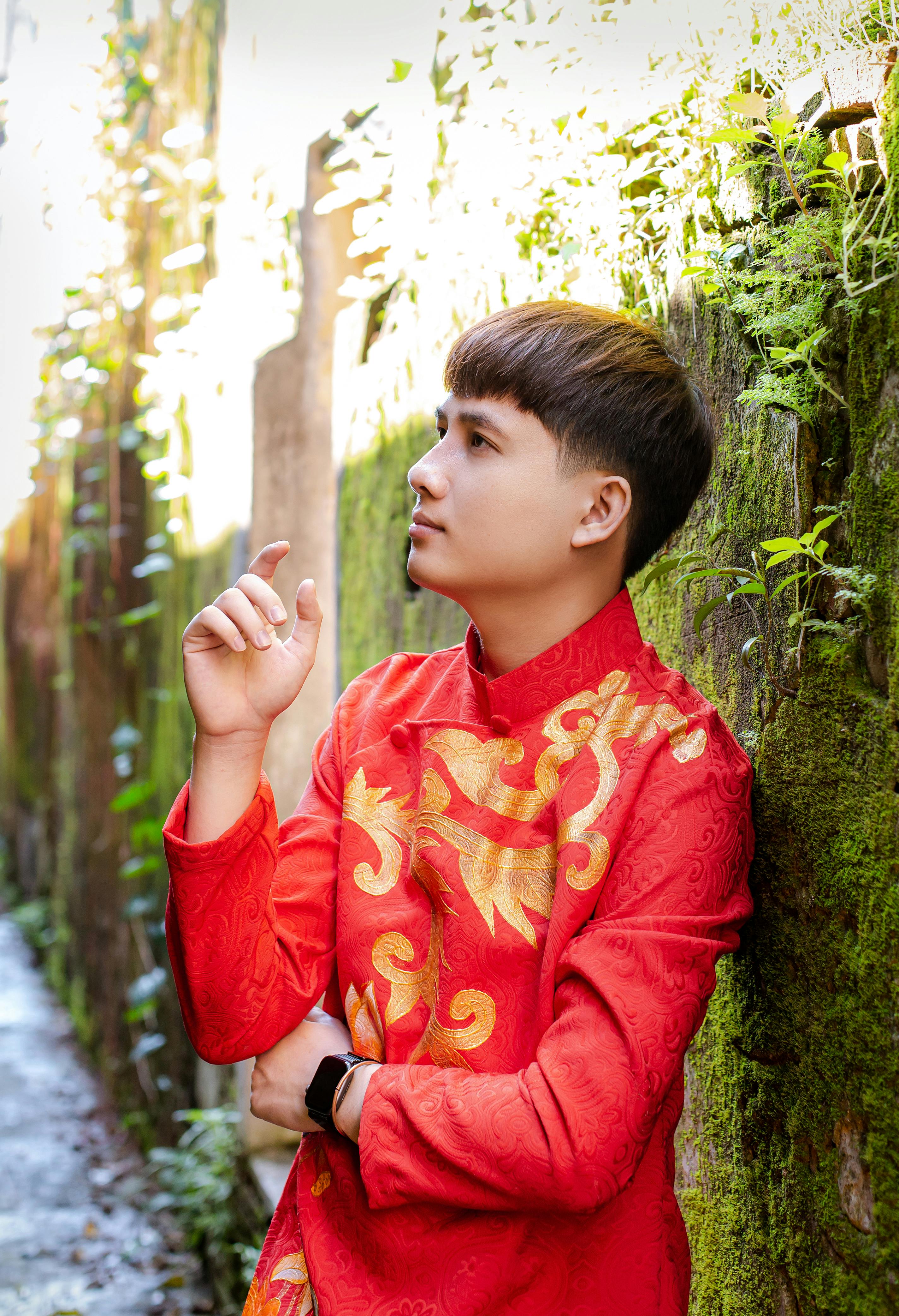 Portrait of a man in traditional Vietnamese Ao Dai in Hội An alley, Quảng Nam, Vietnam.