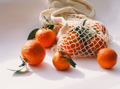 Bright and fresh tangerines in a reusable mesh bag. Perfect for eco-conscious living.