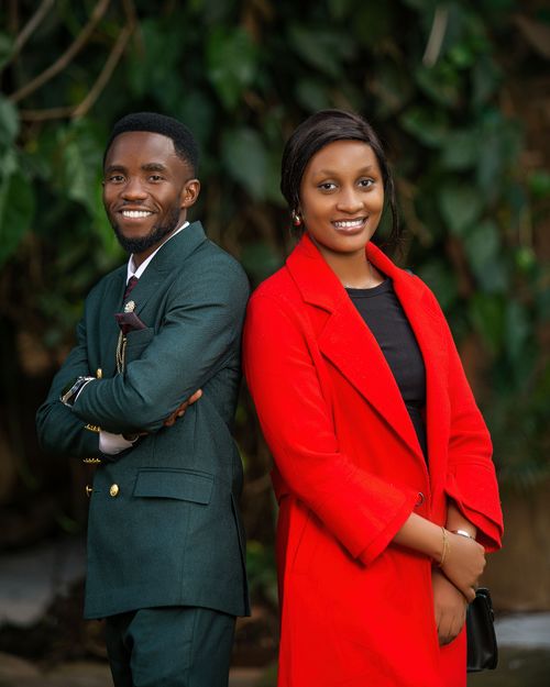 Free Smiling couple in formal wear posing elegantly with a nature backdrop. Stock Photo