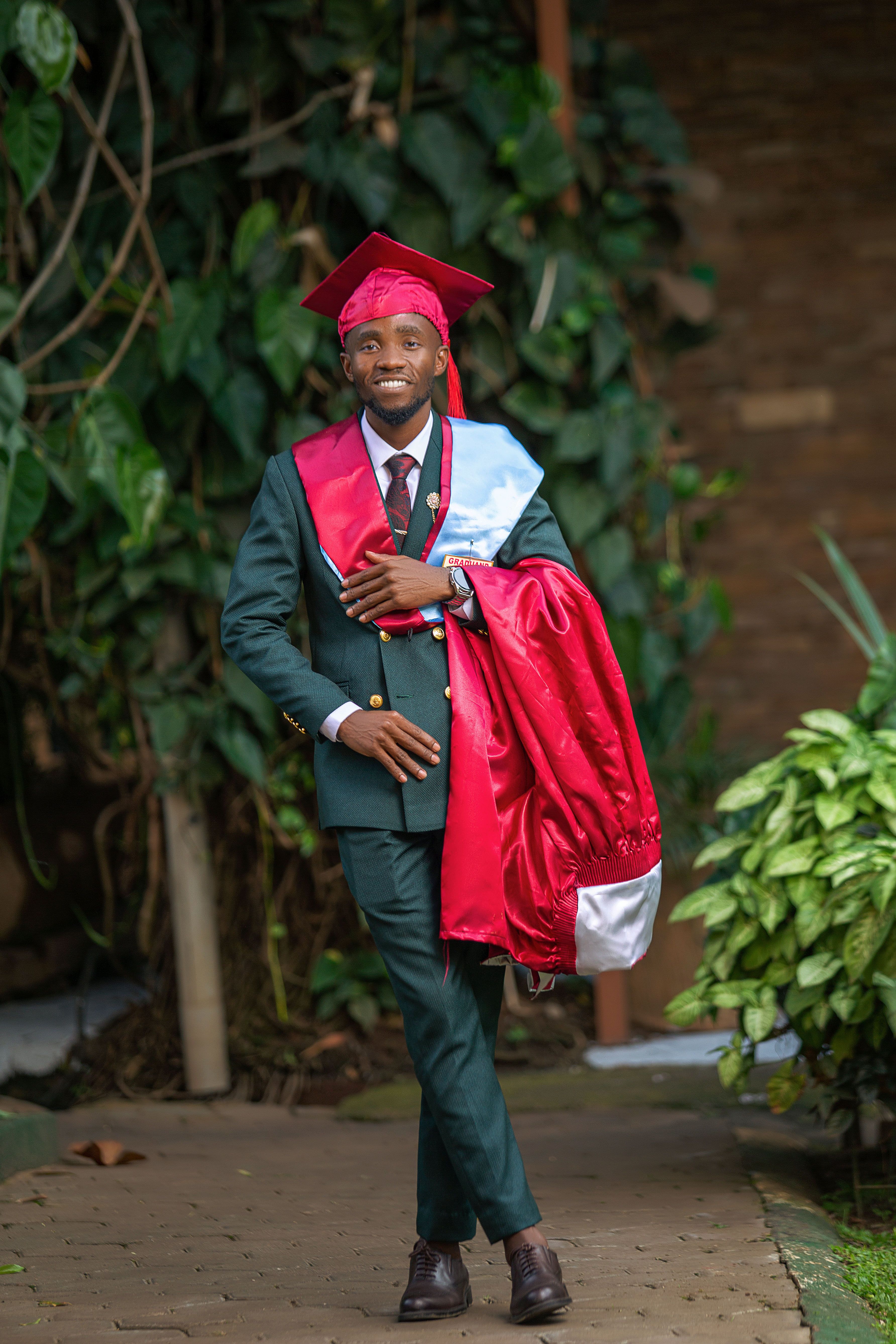 Young Graduate in Cap and Gown Outdoors · Free Stock Photo