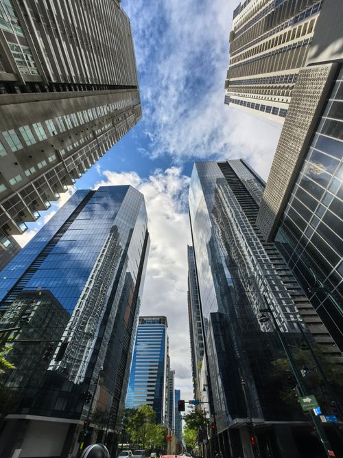 Free Dynamic view of towering skyscrapers in a bustling city under a clear sky. Stock Photo