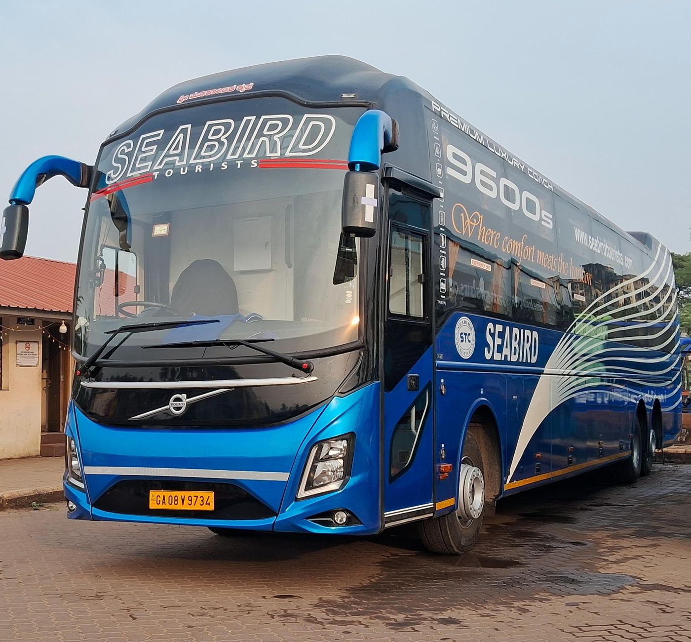 An elegant blue luxury coach bus.