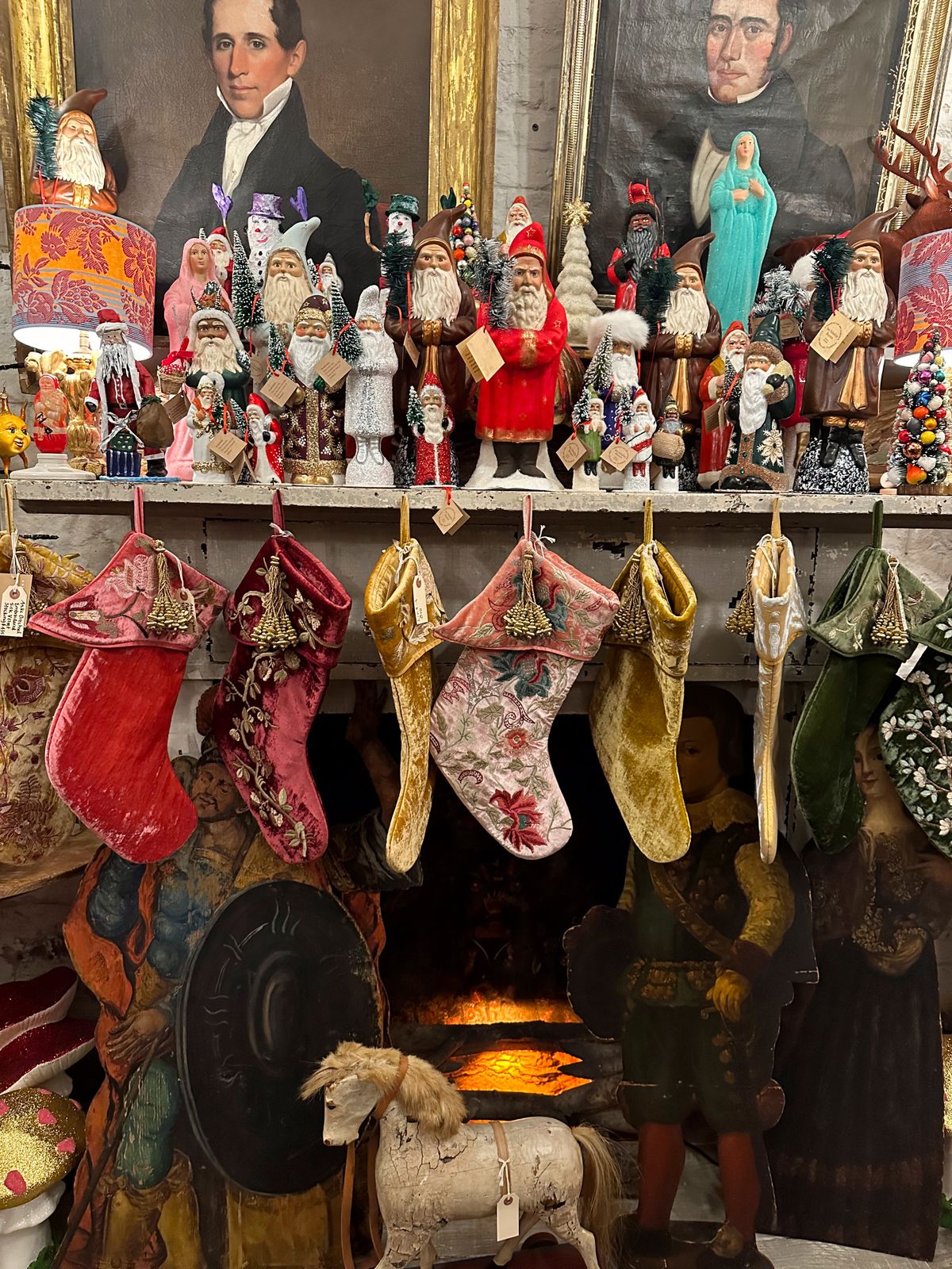 Vintage Christmas mantel with stockings and Santa Claus figurines