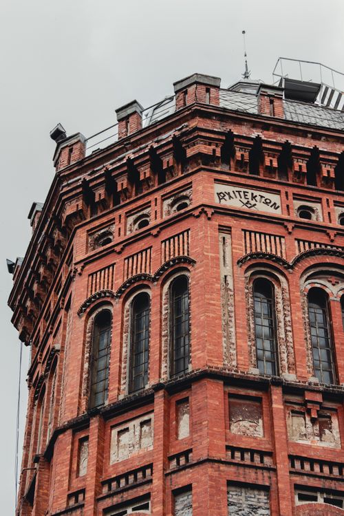 Free Elevated view of a historic red brick architectural tower with detailed masonry. Stock Photo