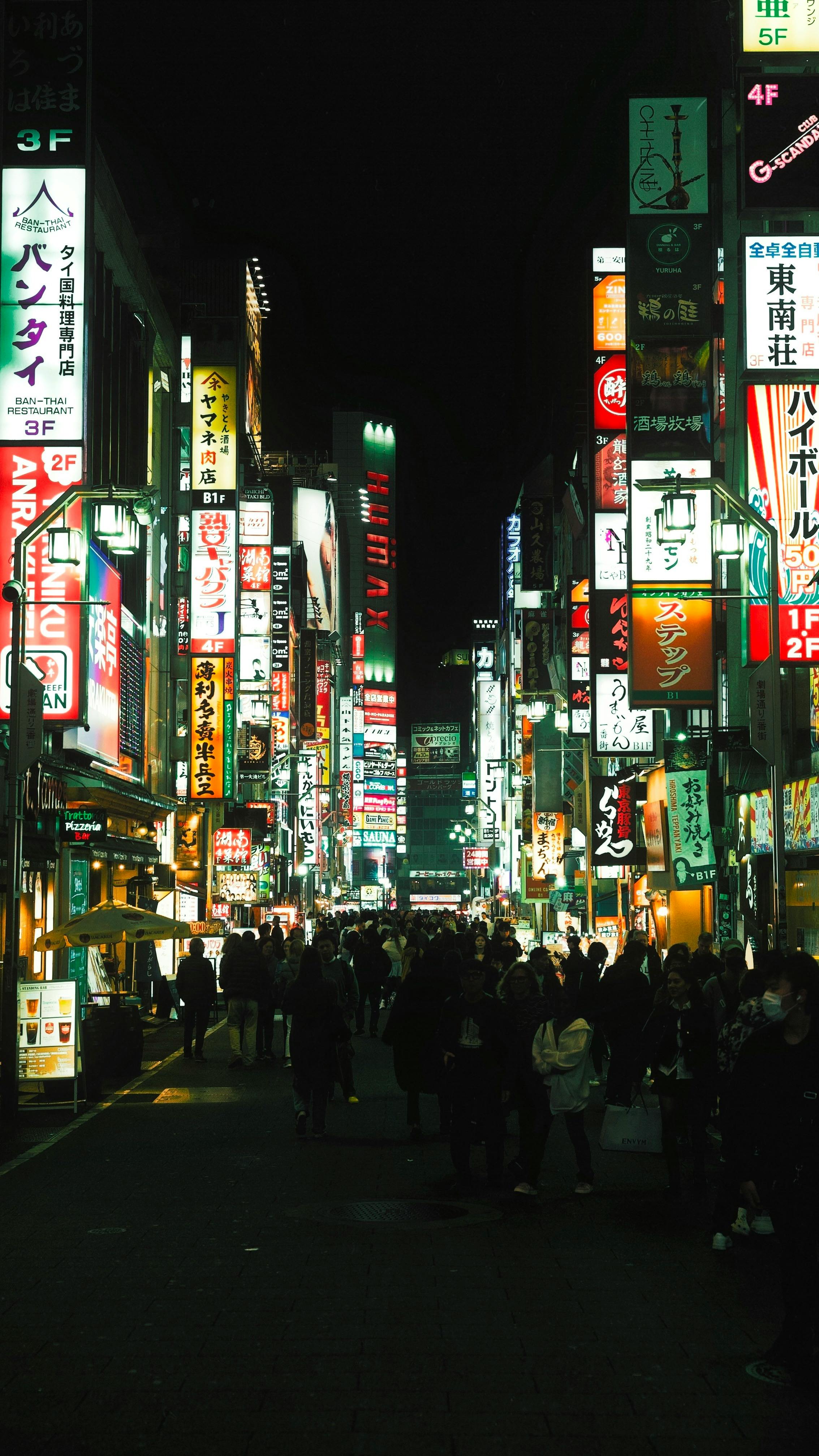 Explore the bustling nightlife of Tokyo's Shinjuku with neon lights and vibrant city life.
