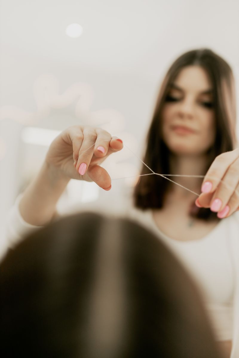 Eyebrow threading by a professional beautician