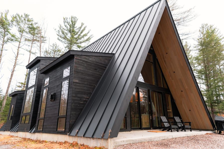 Black A-frame cabin with large windows