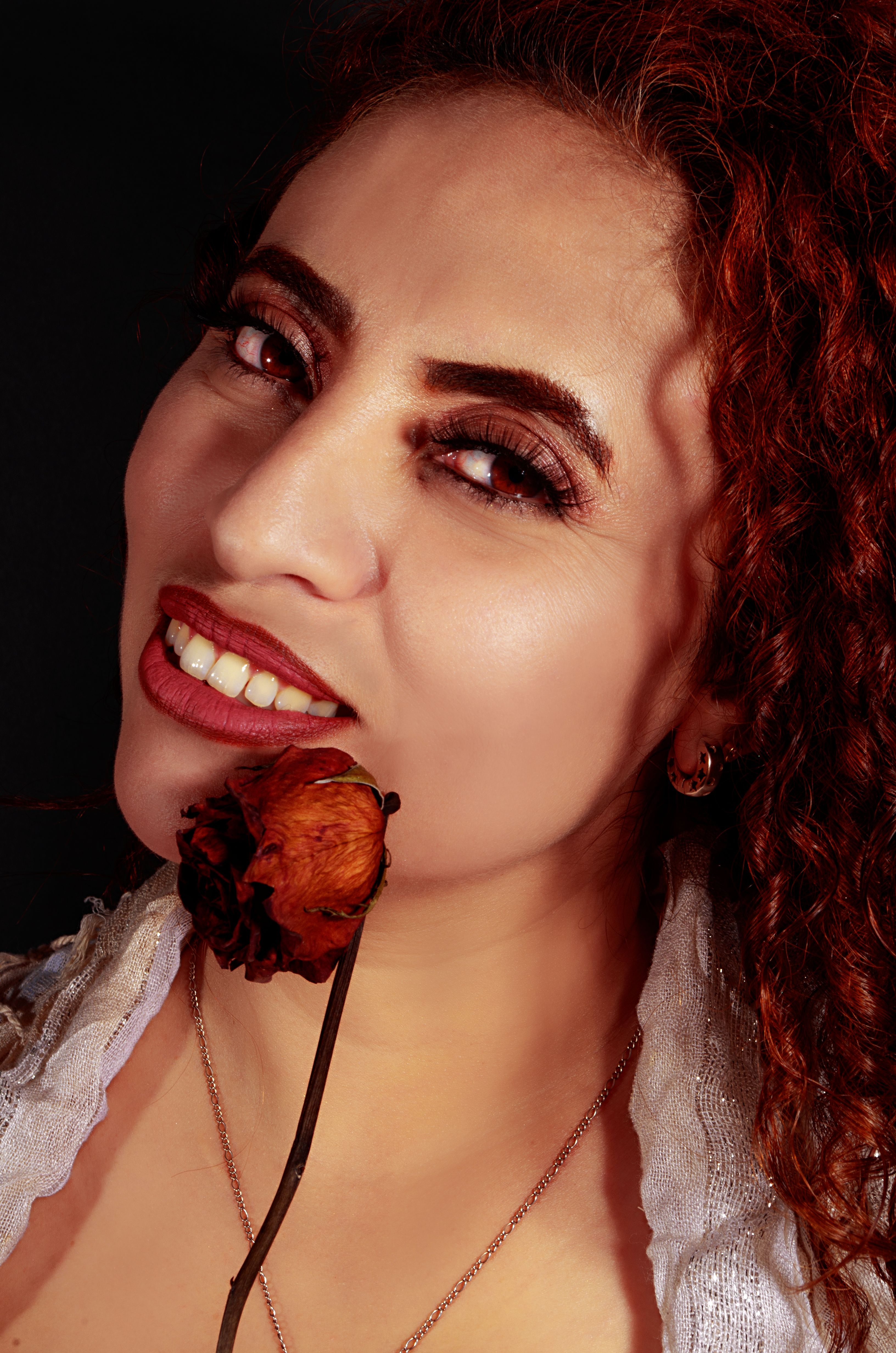 Portrait of a woman with red hair and a dried flower in Ciudad de México.