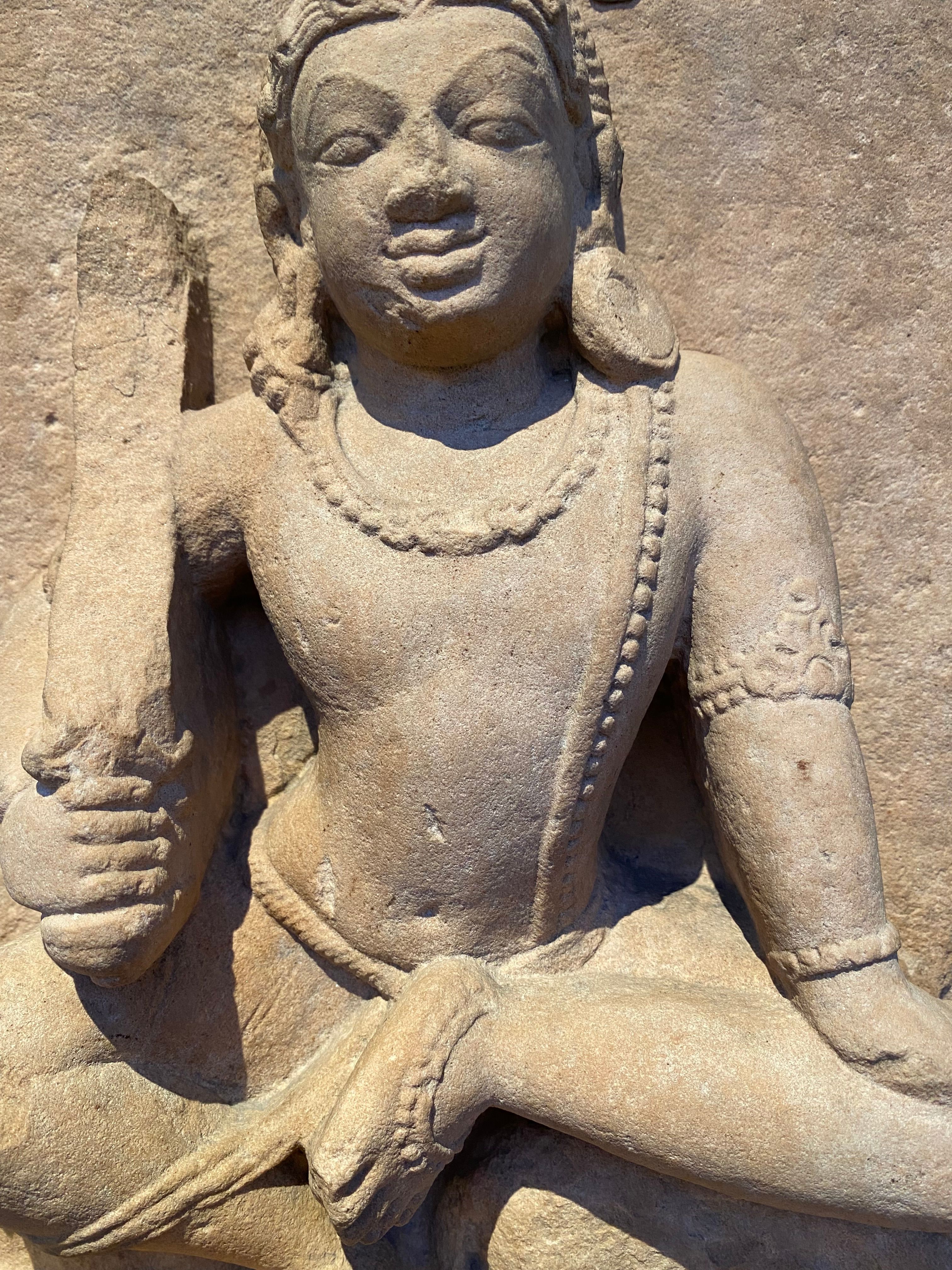 Detailed close-up of an ancient stone sculpture depicting cultural heritage in an Edinburgh museum.