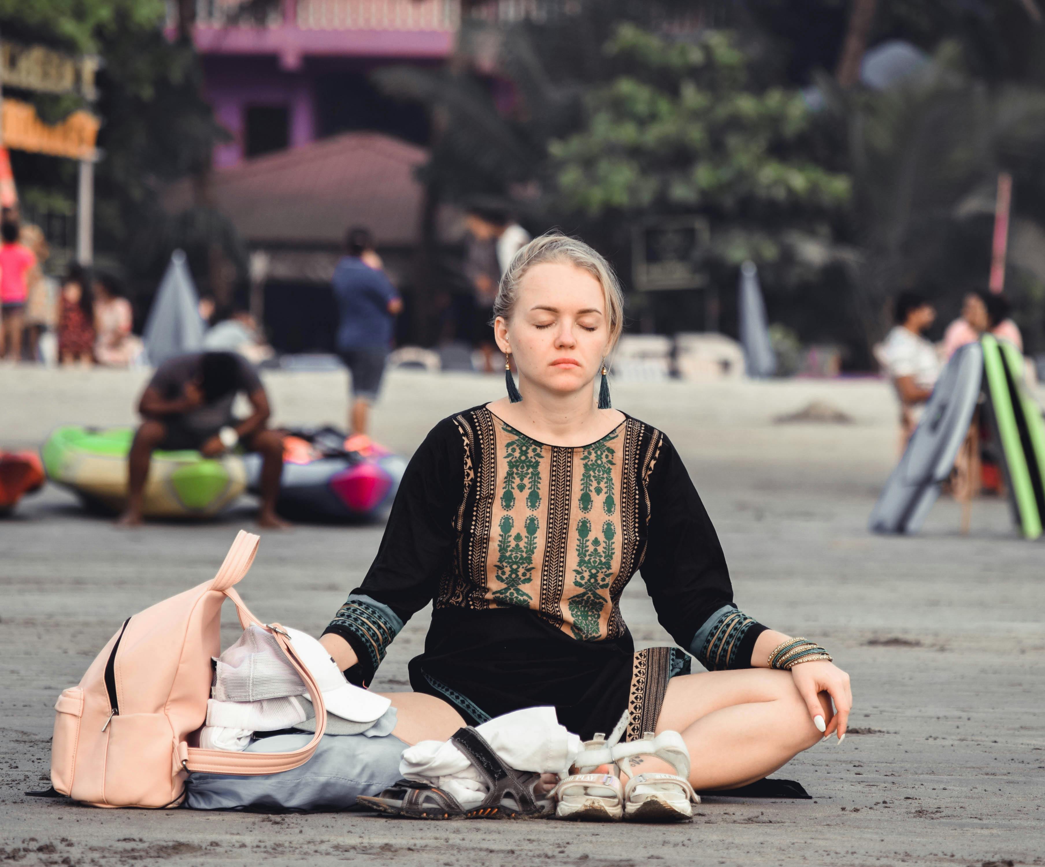 Woman meditating peacefully on a beach