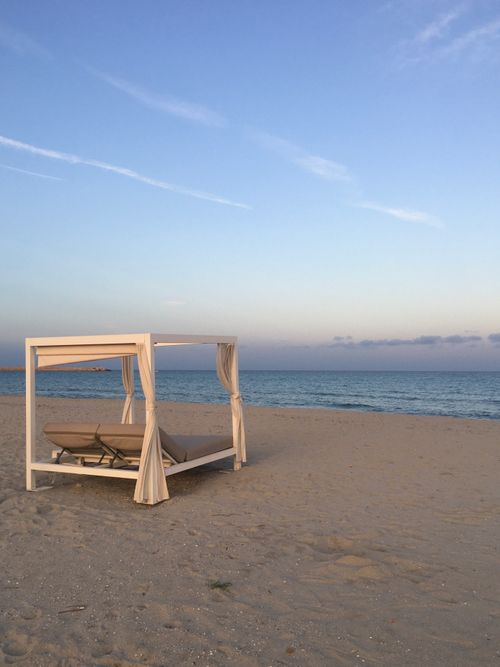 Free Secluded Sardinian beach with cabana at sunset, perfect for relaxation and romance. Stock Photo