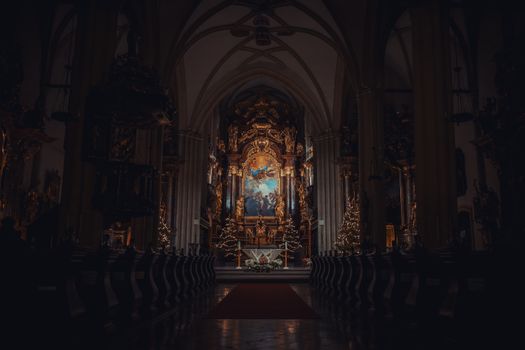 A beautifully detailed cathedral altar with gold accents illuminated in dim light, creating a serene atmosphere.