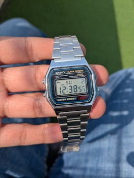 Close-up of a classic Casio digital watch held in hand, showcasing retro style.