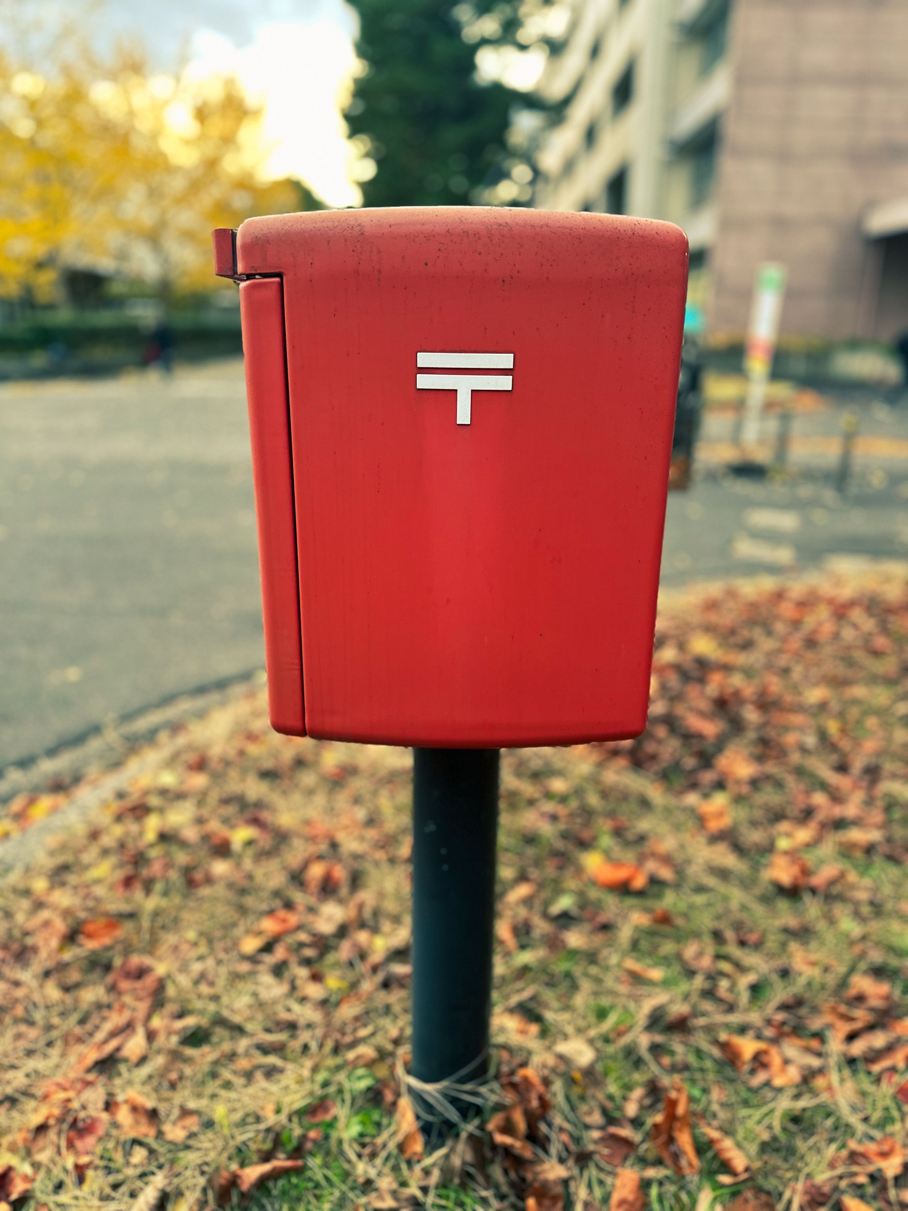 Red Post Box on an Autumn Street · Free Stock Photo
